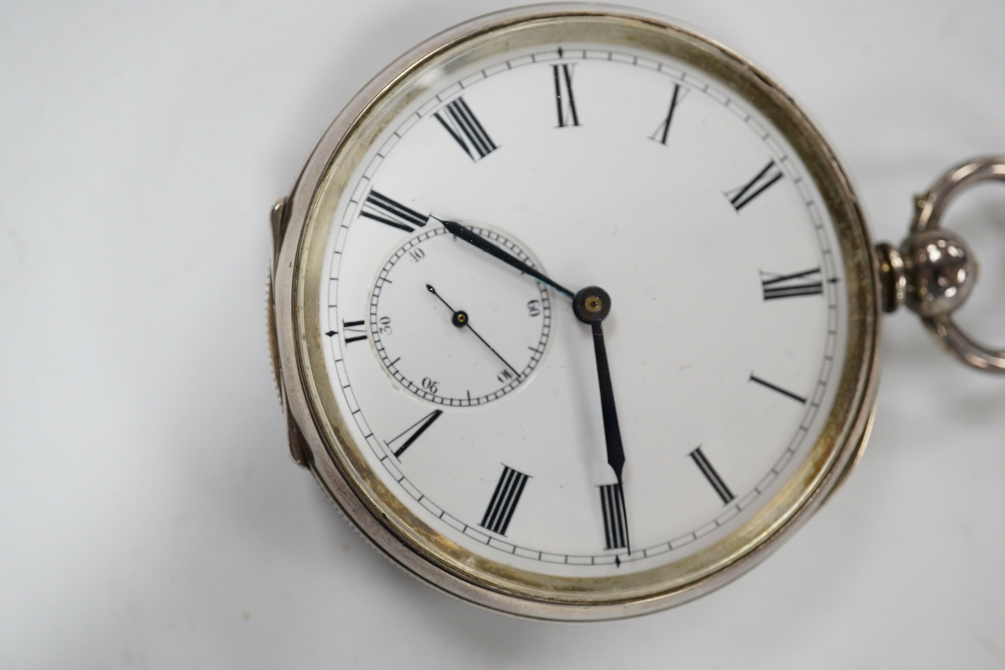 A late 19th century engine turned Swiss 935 standard white metal key wind open faced pocket watch, with engraved inscription relating to J.B. Dent & Sons, London, case diameter 53mm. Condition - fair